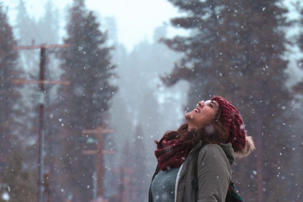 Snow falling woman looking up