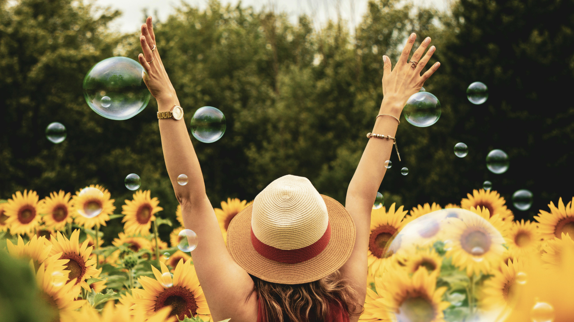 Woman with bubbles in sunflower field